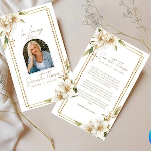 May include: Two-page memorial card with a photo, floral accents, and gold borders. The card includes the text "In Loving Memory of Samantha Thomson" and dates. White lilies and a rosary are featured in the design.
