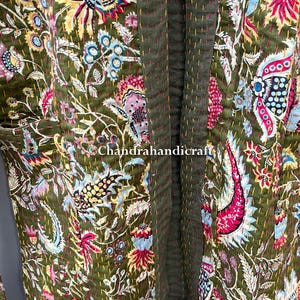 May include: Olive green floral patterned robe with a vibrant mix of pink, blue, yellow, and white accents. The robe features a stitched design and the text "Chandrahandicraft".