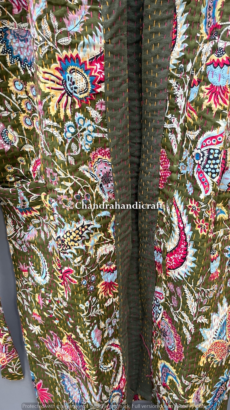 May include: Olive green floral patterned robe with a vibrant mix of pink, blue, yellow, and white accents. The robe features a stitched design and the text "Chandrahandicraft".