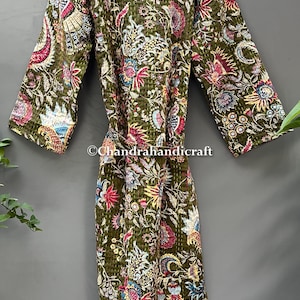 May include: Olive green quilted robe with a vibrant floral pattern in shades of red, blue, yellow, and white. The robe features a belt and long sleeves. The text "Chandrahandicraft" is visible on the robe.