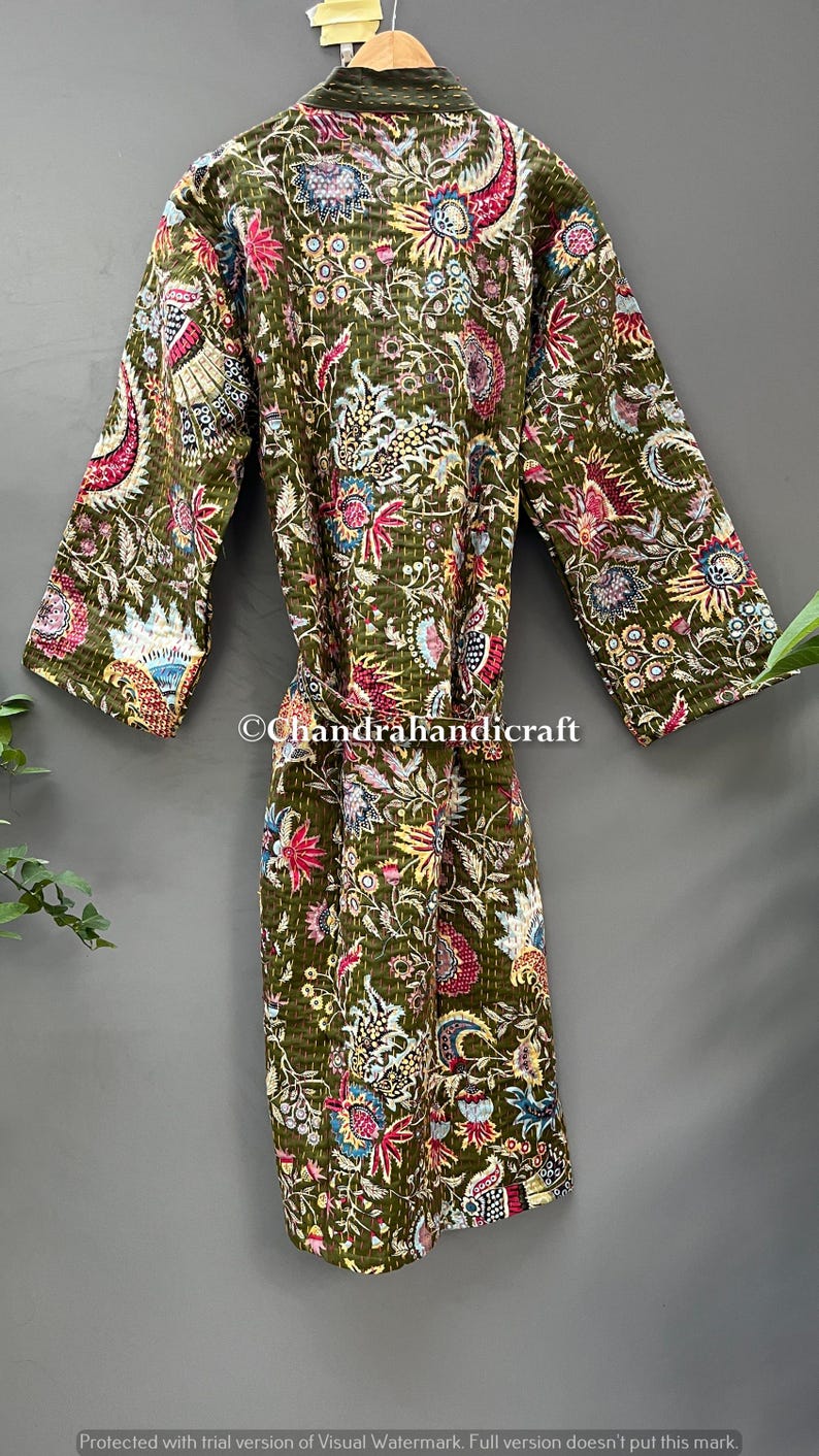 May include: Olive green quilted robe with a vibrant floral pattern in shades of red, blue, yellow, and white. The robe features a belt and long sleeves. The text "Chandrahandicraft" is visible on the robe.
