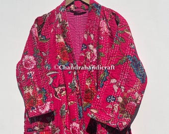 May include: A vibrant pink quilted robe with a floral pattern in shades of red, blue, and green. The robe is hanging on a wooden hanger. The text "Chandrahandicraft" is visible.