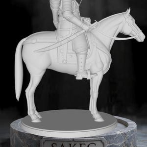 May include: A white sculpture of a rider on horseback, holding a bow and arrow. The rider wears a turban and armor, and a sword is at their side. The sculpture is on a stone base with the name "SAKEG" on a plaque.