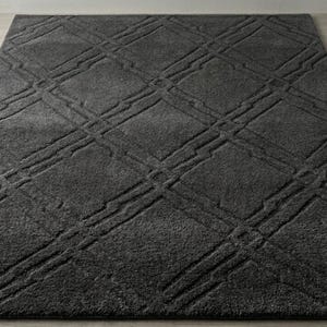 May include: A rectangular area rug in a deep charcoal gray color featuring a raised, textured diamond pattern across the surface. The design consists of intersecting lines that form a grid of squares, creating a subtle three-dimensional effect.