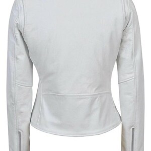 May include: A white leather jacket with a classic biker style. Features include a notched collar, shoulder epaulets, and zippered sleeves. The jacket has a tailored fit and a slightly asymmetrical zipper closure.