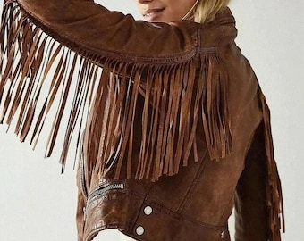 Könnte beinhalten: Braune Lederjacke mit langen Fransen an Ärmeln und Rücken. Die Jacke hat einen Reißverschluss und zwei Druckknöpfe. Ein stilvolles Oberbekleidungsstück im Western-Stil.