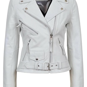 May include: A white leather jacket with a classic biker style. Features include a notched collar, asymmetrical zipper closure, multiple zippered pockets, and a belted waist. The jacket has silver hardware and the label "Carrie Hexton".