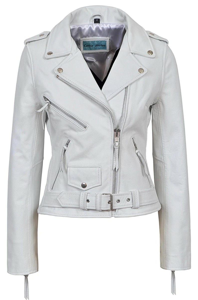 May include: A white leather jacket with a classic biker style. Features include a notched collar, asymmetrical zipper closure, multiple zippered pockets, and a belted waist. The jacket has silver hardware and the label "Carrie Hexton".