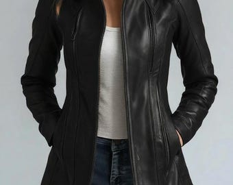May include: A black leather jacket with a stand-up collar and a zipper closure. The jacket has a tailored fit, with vertical seams and pockets. The model is wearing a white top and blue jeans. The jacket is a stylish outerwear option.