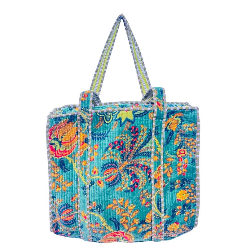 Front view of a blue floral Indian handmade tote bag with velvet texture on white background.