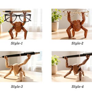 May include: Four wooden crab-shaped desk organizers labeled Style-1, Style-2, Style-3, and Style-4. Each figure features faceted surfaces and raised arms designed to hold items like black-framed glasses, gold-rimmed glasses, or pens.