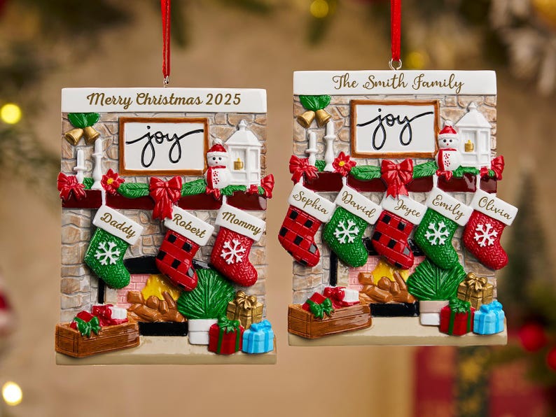 May include: Christmas ornament shaped like a fireplace with stockings and the word "joy". The ornament has the text "Merry Christmas 2025" and "The Smith Family". Stockings are personalized with names.