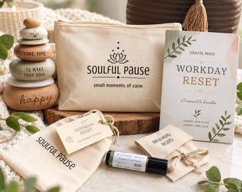 May include: A wellness kit featuring a canvas pouch with the text SOULFUL PAUSE, a Workday Reset journal, a stack of four wooden stones with engraved text, a small bag with prompt cards, a Breathing Beads pouch, and an essential oil roller bottle.