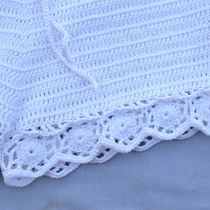 May include: White crochet shorts with a scalloped lace trim. The shorts are made with a simple stitch pattern and have a tie closure at the waist.