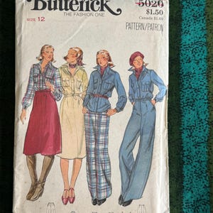 May include: Vintage Butterick sewing pattern, size 12, featuring illustrations of four different outfits. The cover has the text "Butterick THE FASHION ONE" and the price. The outfits include a skirt, pants, and jumpsuit.
