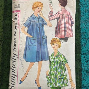 May include: A white ceramic mug with a black handle and the text "But First, Coffee" in a handwritten style. The mug is on a white surface. The mug is 4 inches tall.