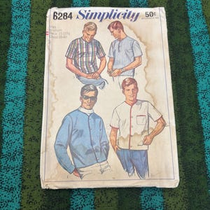 May include: A vintage Simplicity sewing pattern, number 6284, for men's shirts. The pattern includes illustrations of various shirt designs. The pattern is for a medium size, with a neck size of 38-39 cm and a chest size of 97-102 cm.