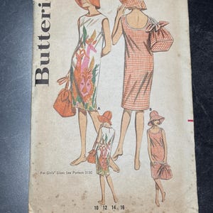 May include: Vintage Butterick sewing pattern featuring illustrations of dresses and accessories. The pattern includes a bust size of 36 and size 16. The price is 60 cents. The pattern also includes instructions for girls' sizes.