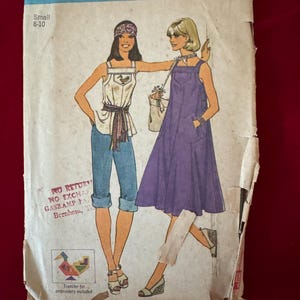May include: Vintage Simplicity sewing pattern, featuring illustrations of two women in 1970s-style outfits. The pattern includes a tank top, capri pants, and a dress. The pattern is labeled "7542" and "Small 8-10".