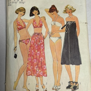May include: Vintage Simplicity sewing pattern envelope featuring illustrations of four women in swimwear and a dress. The pattern includes sizes 6 and 8, with bust measurements of 30.5 and 31.5 inches. The envelope has the number 7490 and the text "Stretch Knits Only".