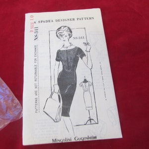 May include: A vintage sewing pattern for a dress, size 10, by Spadea Designer Pattern. The pattern number is NS-341. The pattern features a black and white illustration of a woman wearing a dress with a boat neck and short sleeves. The pattern is titled "Mingolini Guggenheim".