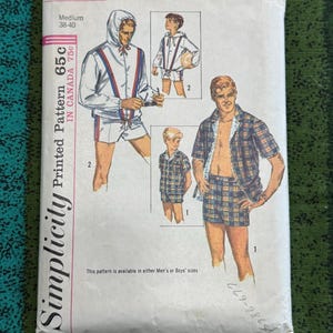 May include: Vintage Simplicity printed pattern packet, featuring illustrations of men's or boys' clothing. The packet includes a hooded jacket, shorts, and a plaid shirt and shorts set. The packet is marked with the number 5997 and the text "Medium 38-40".