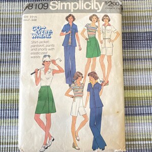 May include: Vintage Simplicity sewing pattern, size 22 1/2, featuring illustrations of shirt-jackets, pantskirts, pants, and shorts with elasticized waists. The pattern cover has the text "GO EVERYWHERE".