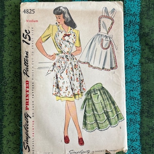 May include: Vintage Simplicity printed pattern 4825 for aprons. The cover art features a woman in a yellow top and floral apron, with illustrations of different apron styles. The pattern is marked "Medium" and priced at 15 cents.