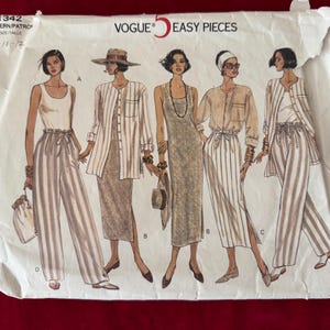May include: Vogue 5 Easy Pieces sewing pattern. The pattern features illustrations of five different outfits, including striped pants, skirts, and jackets. The pattern envelope is white with black text and illustrations.