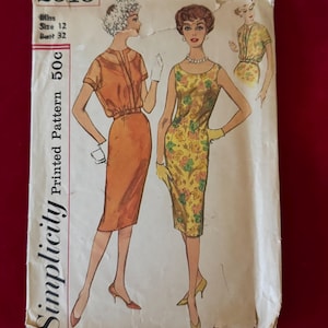 May include: Vintage Simplicity sewing pattern number 2916 for a dress. The pattern is for a size 12 with a 32 inch bust. The pattern is printed on white paper with a yellowed tint and has a price of 50 cents.