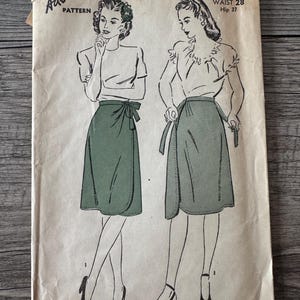 May include: Vintage Advance Pattern 3745, featuring illustrations of two women in wrap skirts and blouses. The cover is aged with text reading "15c" and "Advance Pattern." Measurements are listed as Waist 28 and Hip 37.