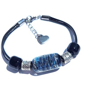 Custom-sized bracelet with black ashes-infused bead, two handmade matching beads and metal accents. Handmade to order by DragonFire Glass
