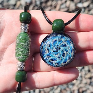 Green Cremation Jewelry Set with ashes-infused pendant and matching bracelet. Made to order by DragonFire Glass