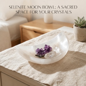 May include: A white, crescent moon-shaped selenite bowl containing purple amethyst and clear quartz crystal clusters. The text SELENITE MOON BOWL: A SACRED SPACE FOR YOUR CRYSTALS is printed above the bowl in a dark, sans-serif font.