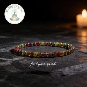 May include: A beaded bracelet with red, green, and brown stones. The bracelet is strung on an elastic cord. The text "find your spark" is below the bracelet. The logo for "Mind Refreshing Stone" is in the upper left corner.