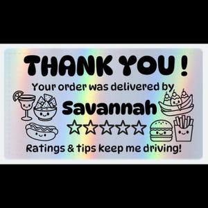 May include: A holographic sticker with the words "THANK YOU!" in bold black letters. Below, it reads "Your order was delivered by Savannah" with a five-star rating graphic. The sticker includes food illustrations and the text "Ratings & tips keep me driving!"