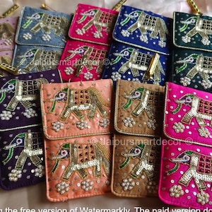 May include: A collection of colorful, embroidered elephant-themed pouches. The pouches are in various colors, including pink, blue, green, and purple, with gold and silver embellishments. Each pouch features a detailed elephant design.
