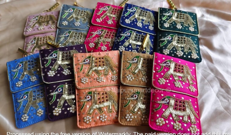 May include: A collection of colorful, embroidered elephant-themed pouches. The pouches are in various colors, including pink, blue, green, and purple, with gold and silver embellishments. Each pouch features a detailed elephant design.