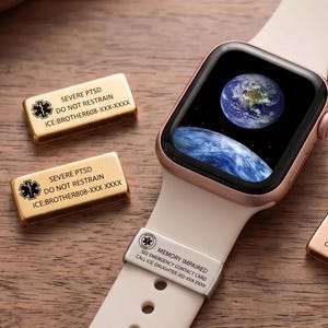 May include: A smartwatch with a light-coloured silicone band featuring a digital earth display. Four small rectangular metal medical alert tags are shown, three gold-toned and one silver-toned, with engraved medical information and symbols.