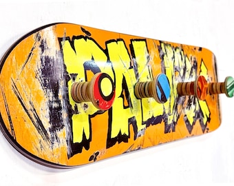 Recycled Skateboard Coat Rack: Wall Mounted with Peg Hooks. Orange Board with Comic Book Style Type Design