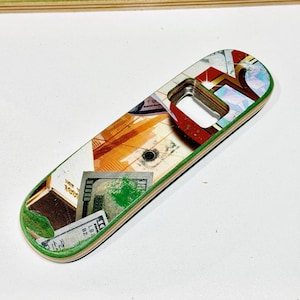 May include: A bottle opener made from a skateboard deck. The opener features a colorful collage design with green edges and a metal bottle cap opener. The design includes images of money and other graphics.