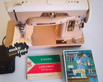 May include: Vintage Singer sewing machine in cream and tan with a foot pedal and accessories. The machine has the Singer logo and model information. The image also includes the text "make/find".