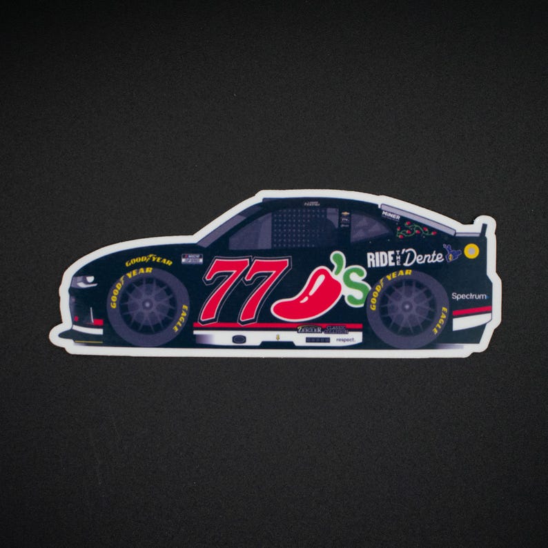 May include: A sticker depicting a black race car with the number 77 in red and a red chili pepper graphic. The car has the words "RIDE'N DENTE" and "GOOD YEAR" on the tyres.