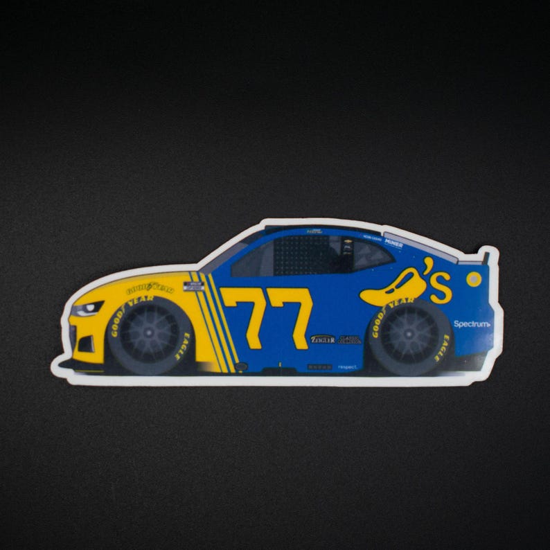 May include: A sticker depicting a blue and yellow race car, number 77. The car features the Goodyear and Spectrum logos, and a chili pepper logo. The car is a side profile.
