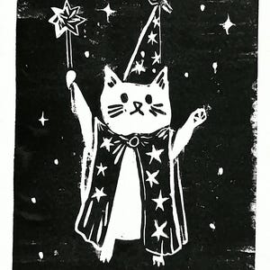 May include: Black and white illustration of a cat dressed as a wizard, holding a star-tipped wand. The cat wears a wizard hat and a cape adorned with stars, set against a starry background. A whimsical design.