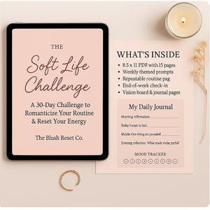 May include: A digital tablet displays "The Soft Life Challenge" text, a 30-day challenge to romanticize your routine. Accompanying it is a journal page with prompts and a mood tracker. A gold ring and a lit candle are also present.