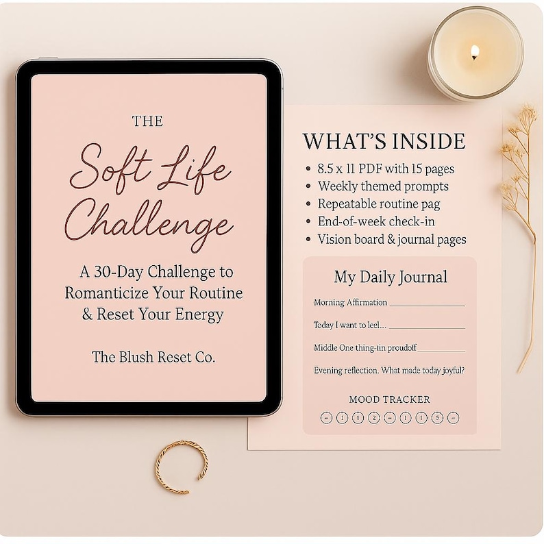 May include: A digital tablet displays "The Soft Life Challenge" text, a 30-day challenge to romanticize your routine. Accompanying it is a journal page with prompts and a mood tracker. A gold ring and a lit candle are also present.