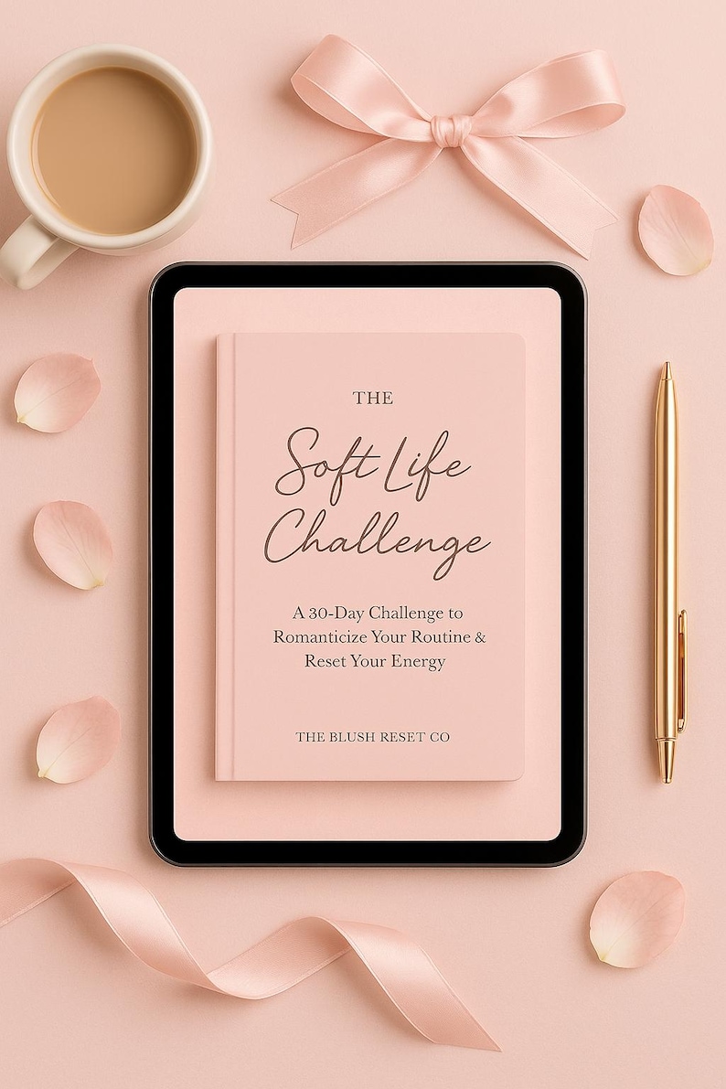 May include: A soft pink book titled "The Soft Life Challenge" with a gold pen, a cup of coffee, and a pink bow on a pink background. The book's subtitle reads "A 30-Day Challenge to Romanticize Your Routine & Reset Your Energy."