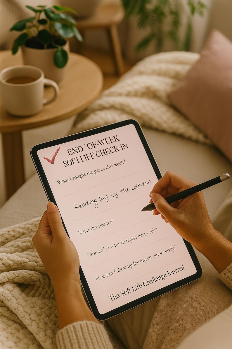 May include: A person is writing on a digital tablet with a stylus. The tablet displays a "Sofi Life Challenge Journal" with prompts for self-reflection, including "What brought me peace this week?" and "Reading ling by the window."
