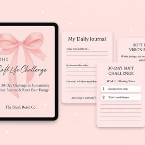 May include: A digital tablet and several pink paper cards with text. The tablet displays "The Soft Life Challenge" with a bow graphic. The cards include "My Daily Journal," "Soft Life Vision Board," and a "30-Day Soft Challenge" guide.